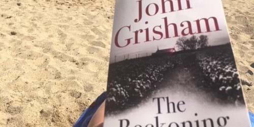 Reading The Reckoning on the beach