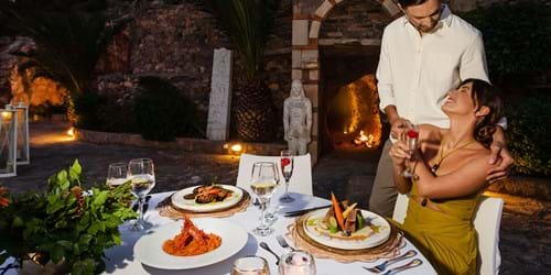 Couple dining at private dining cave at Wydnham Grand Crete Mirabello Bay